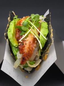 sushi rice, fresh water eel, lettuce, avocado, cucumber, grilled onion, sweet sauce, sesame seed, furikake, kaiware Unagi Taco
