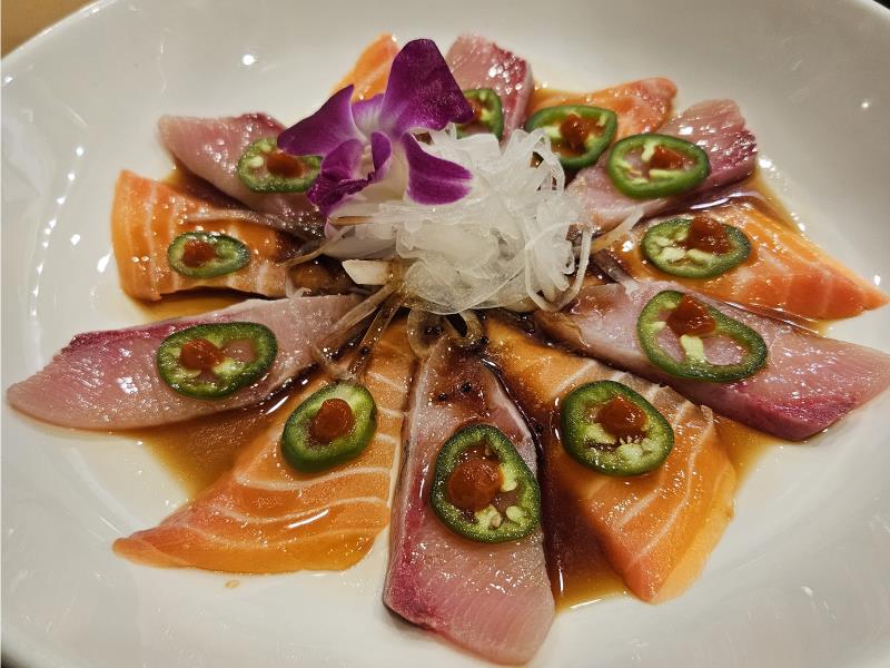 Twelve pieces of thinly sliced salmon with jalapeño, red sauce, shredded radish, and a flower garnish. Other fish options available Sake Special (12Pcs)