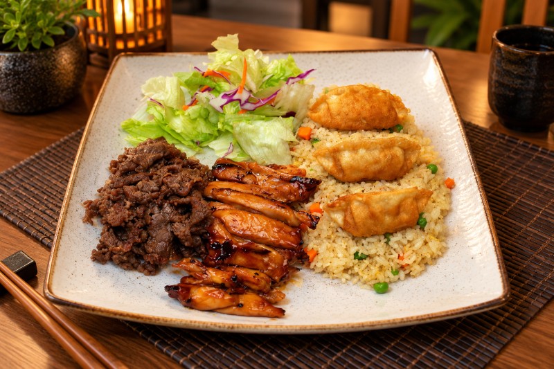 Chicken and beef teriyaki, gyoza (3 pieces), fried rice, and green salad. C19_Triple Combo