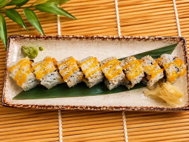 Hot. Spicy salmon and cucumber topped with orange sauce and green onion. R9_Spicy Salmon Roll
