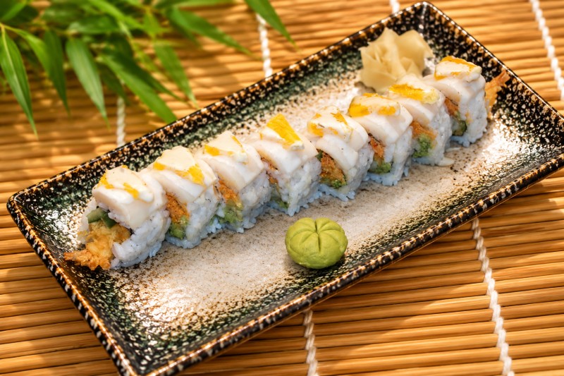 Hot. Shrimp tempura roll, snow crab topped with white tuna, orange and yuzu mayo sauce. R23_Yummy Yummy Roll