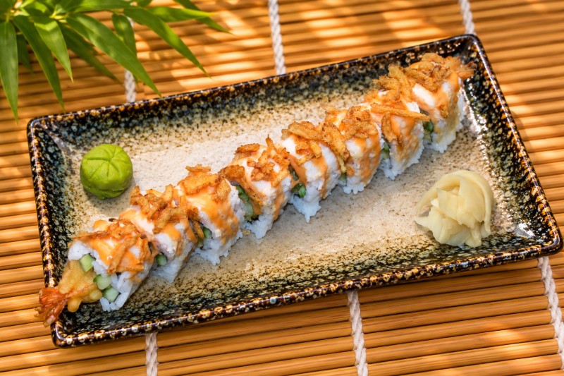 Hot. Shrimp tempura roll topped with spicy crab salad and crispy onions. R26_Dynamite Roll