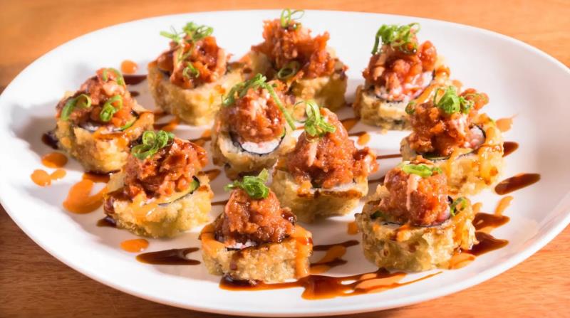 In: Crab meat, Avocado -> Fry
Out: Laying down pieces - Spicy tuna on top
Top: Eel sauce, Spicy mayo, Green onion
 Volcano