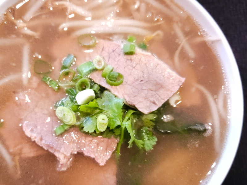A Small-sized bowl of flavorsome Pho!
A popular Vietnamese soup of rice noodles with an aromatic Beef broth simmered for many hours.
Served with Protein of choice, Cilantro, Bean Sprouts, and Green Onions. Thai Basil and Lime Slices on the side. Rk Pho Small Bowl