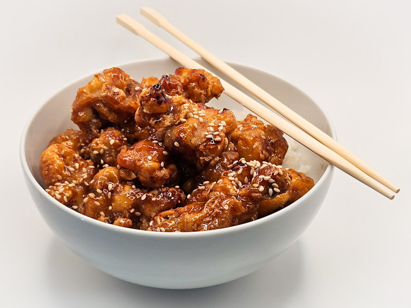 A serving of our house special Orange Chicken over a bowl of white rice. Orange Chicken Bowl