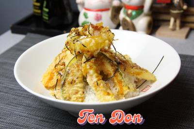 A bowl of rice topped with crispy shrimp and vegetable tempura Tempura Donburi