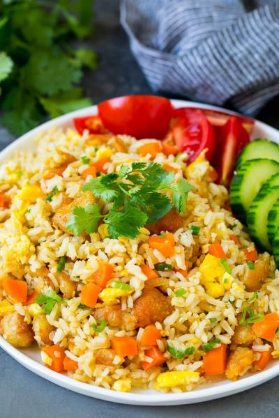 CHICKEN FRIED RICE IS A POPULAR HOT DISH MADE BY STIR-FRYING COOKED RICE, PIECES OF CHICKEN, EGGS, AND VEGETABLES IN A PAN OR WOK. Chicken Fried Rice