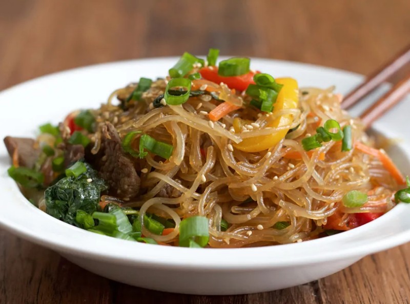 Stir-fried glass noodles with beef and mixed vegetables in a light soy-sesame sauce — savory, slightly sweet, and delicious. Japchae