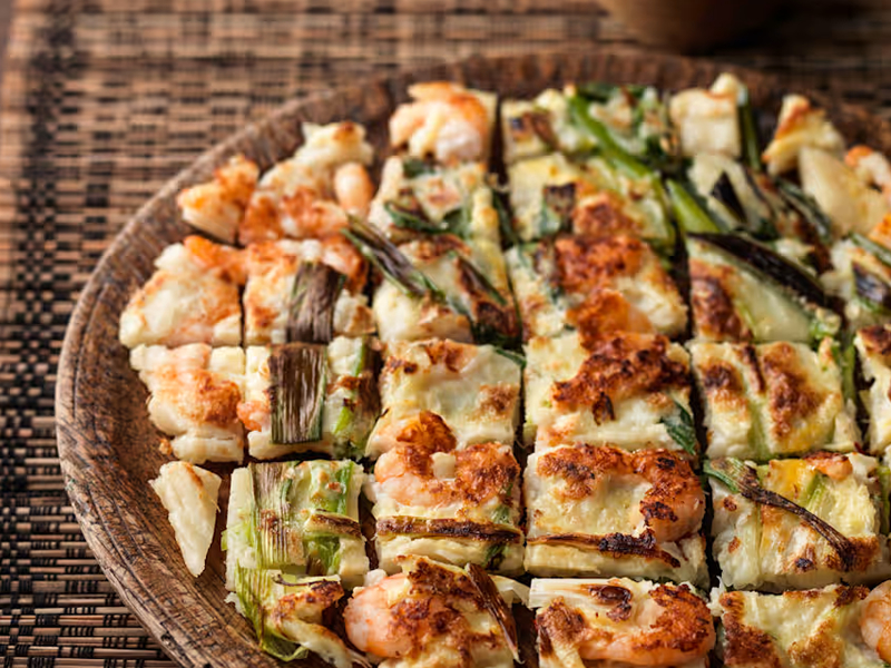 Golden-brown pancake packed with assorted seafood and green onions, pan-fried for a crisp outside and tender inside. Seafood Pancake