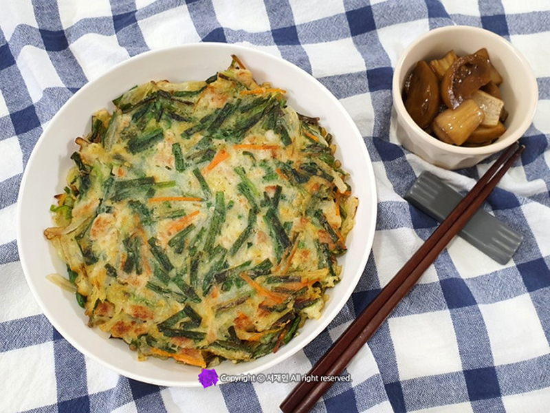 Crispy Korean pancake made with fresh chives and mixed vegetables in a light flour batter. Chive Pancake