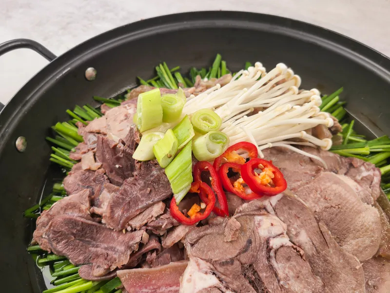 Rich beef broth simmered with tender brisket slices, assorted vegetables, and tofu — hearty and comforting hot pot. Boiled Brisket Hot Pot