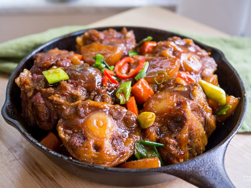 Tender oxtail braised in a rich, spicy sauce with vegetables — bold, hearty, and full of deep flavor. Spicy Braised Ox Tail