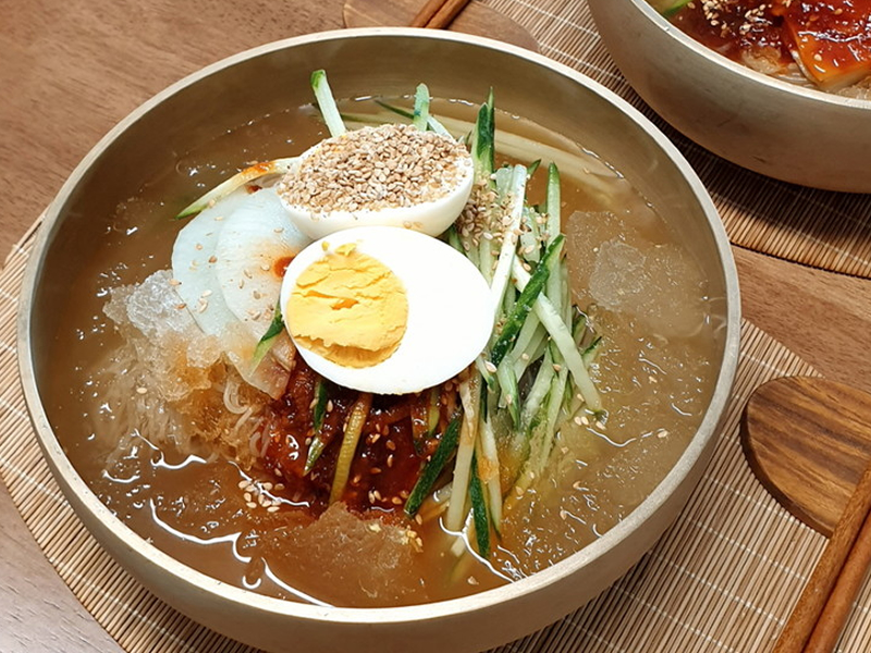 Chewy buckwheat noodles served in an icy, tangy beef broth — refreshing and perfect for a cool, clean taste. Cold Noodle