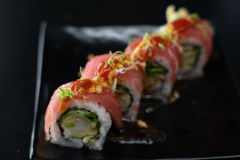 In: Shrimp tempura, sliced jalapeno, cucumber | Out: Tuna | Top: Mustard dressing, sp. mayo, eel sauce, chilli oil, sriracha, green onion, garlic chip Crispy Garlic Chip On Tuna