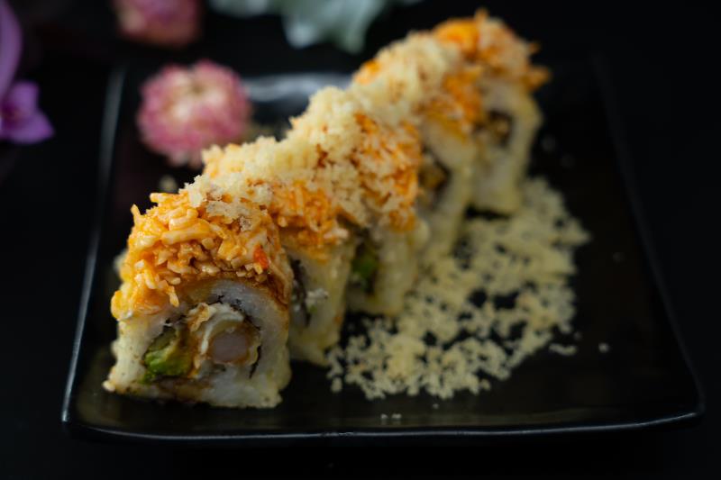 "In: Avocado, cream cheese, shrimp tempura | Out Fried | Top: Sp. krabmeat, tempura flakes, eel sauce
" Golden Bridge