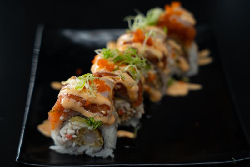 In: Shrimp tempura, krabmeat, avocado | Out:Sp. tuna, bay scallop | Top: Sp. mayo, eel sauce, masago, green onion Sensual Pleasure