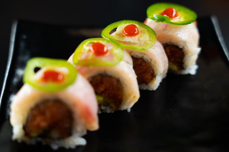 In: Sp. tuna, avocado, cilantro | Out: Yellowtail | Top: Mustard dressing, sliced jalapeno Angry Tail