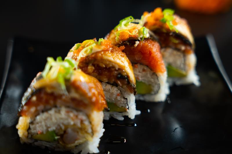 In: Shrimp tempura, krabmeat, avocado | Out: Sp. albacore, eel | Top: Sp. mayo, eel sauce, green onion, masago Lord Of Dragon