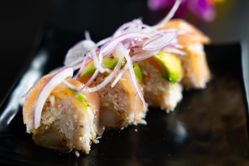 In: Shrimp tempura, krabmeat | Out: Albacore, avocado | Top: Mustard dressing, red onion, garlic butter Mokuzai