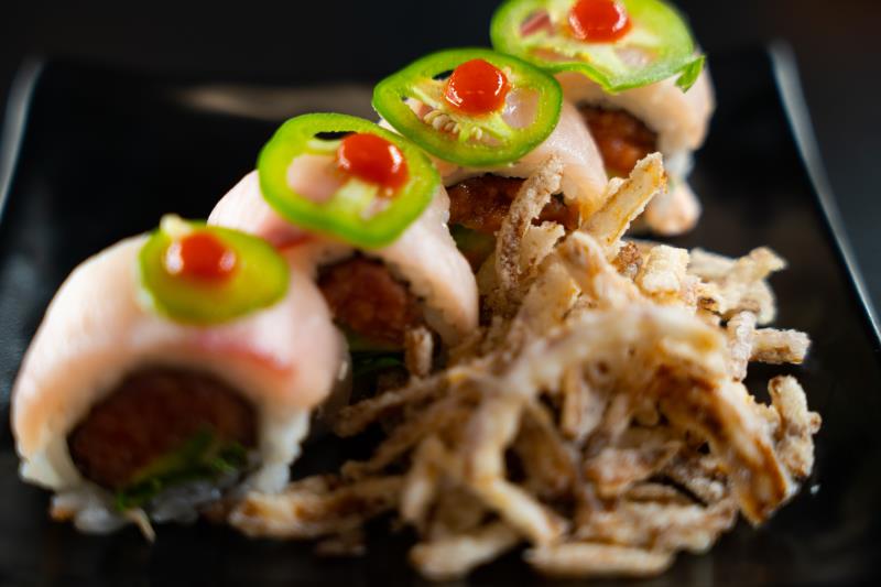 In: Sp. tuna, avocado, cilantro | Out: Yellowtail | Top: Ponzu, sriracha, sliced jalapeno, crispy onion Yellowtail Crispy Onion