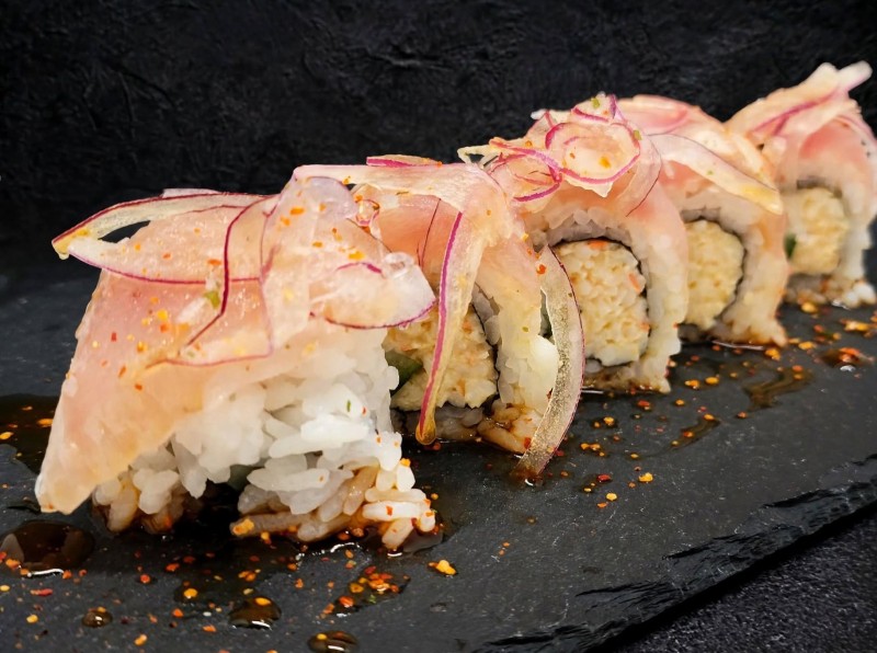 Spicy Crabmix, Cucumber inside. Albacore on top Spicy Ponzu Sauce. Red Onion and Chili Powder on top. Albacore Roll