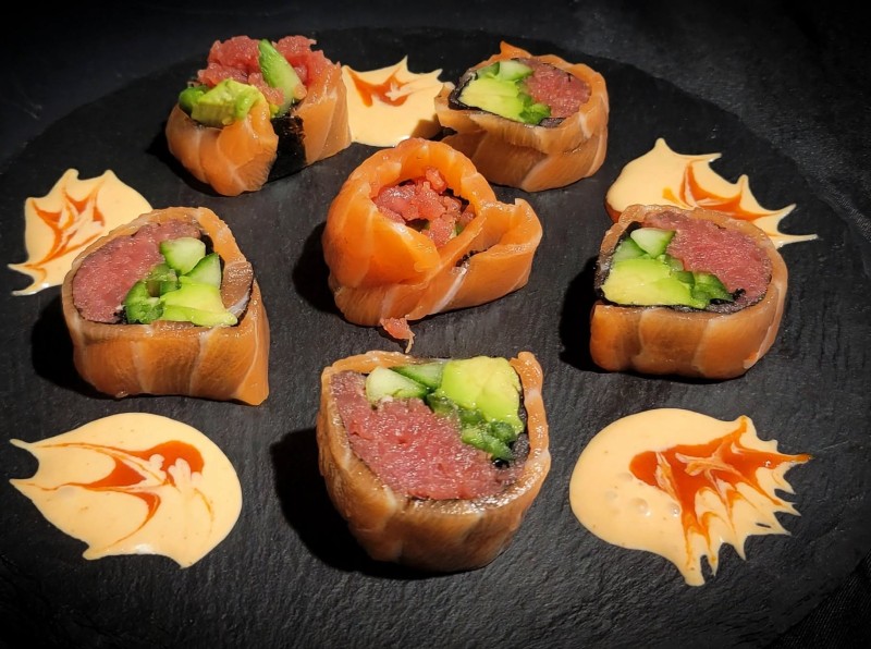 Spicy Tuna, Cucumber, Jalapeno, Avocado Wrapped Salmon. Spicy Mayo and Spicy Sauce. Atomic Roll