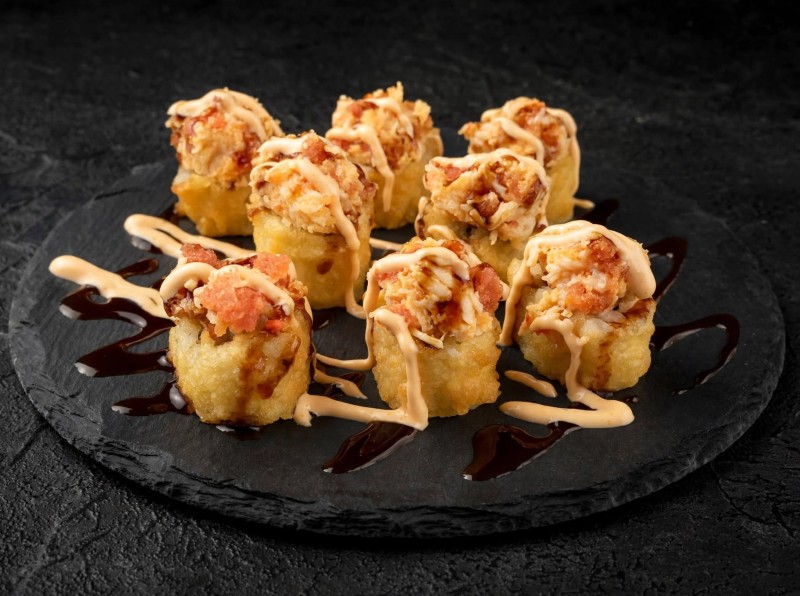 California Roll Deep Fried. Spicy Tuna & Spicy Crab Mix on top. Eel Sauce, Spicy Mayo on top. Az Roll