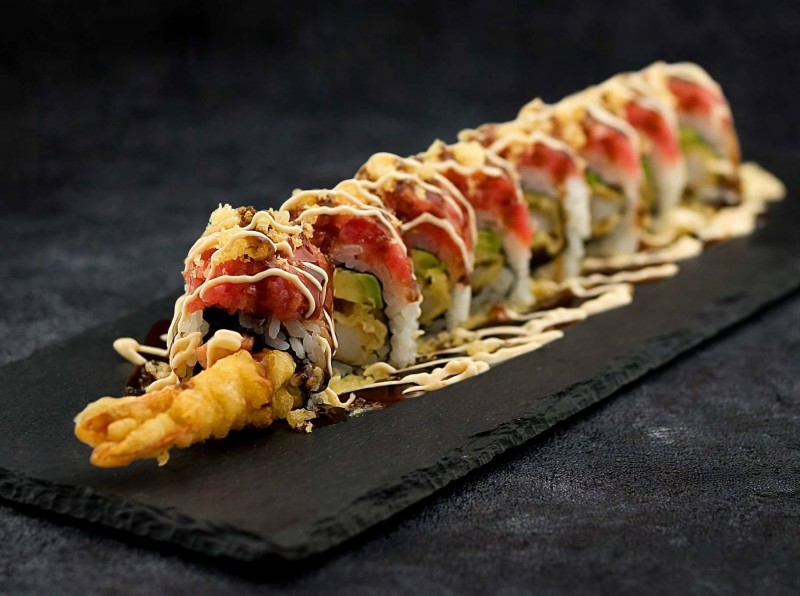 Shrimp Tempura, Avocado, Cream Cheese, Crab inside. Spicy Tuna, Crunch Bit on top Eel Sauce, Spicy Mayo on top. Crazy Shrimp Roll