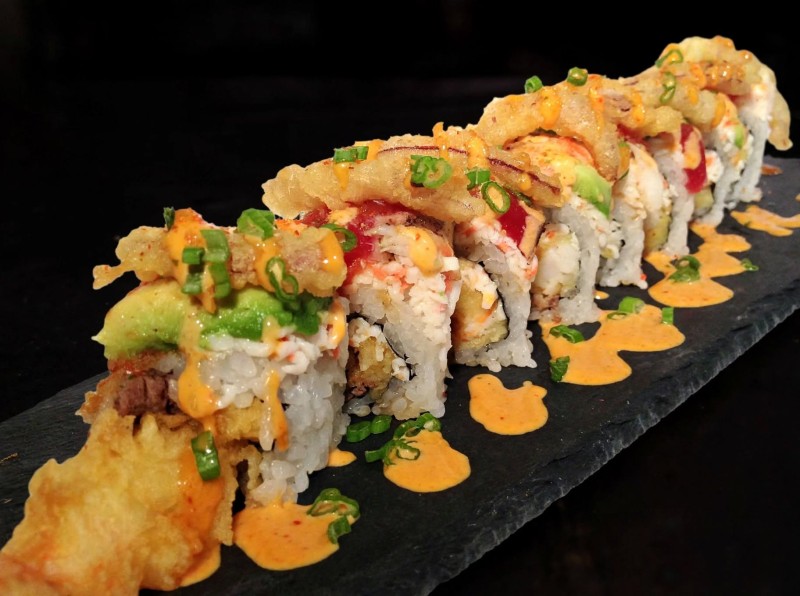 Shrimp Tempura, King Crab Mix, Tenderloin inside. Spicy Crab mix on top.
Seared Tuna, Ebi Shrimp Avocado, Tempura Red Onion on top. Geisha Sauce. Deluxe S & T