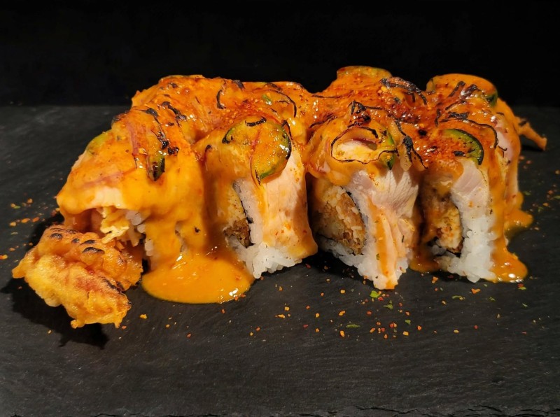 Shrimp Tempura, Spicy Tuna, Crab Mix Inside. Tuna, Salmon, Yellowtail, White Fish on top. Spicy Wasabi Mayo Sauce, Jalapeno, and Red Onion on top. Torch. Geisha Roll