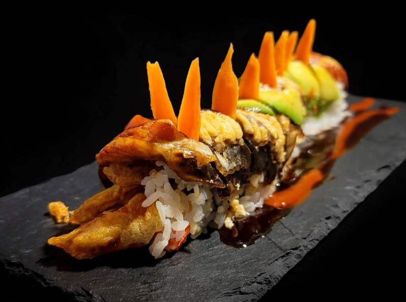 Soft Shell Crab, Cucumber, Crab inside. Eel, Avocado on top. Eel Sauce. Happy Dragon Roll (Softshell Crab)