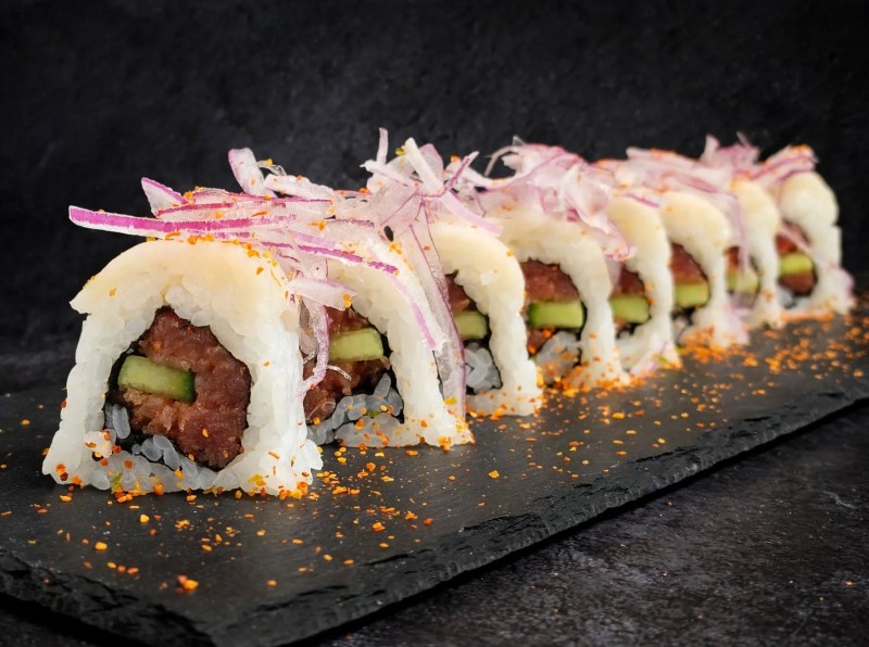 Spicy Tuna, Cucumber inside. White Tuna on top. Red Onion Spicy Ponzu Sauce on top. J.j. Roll