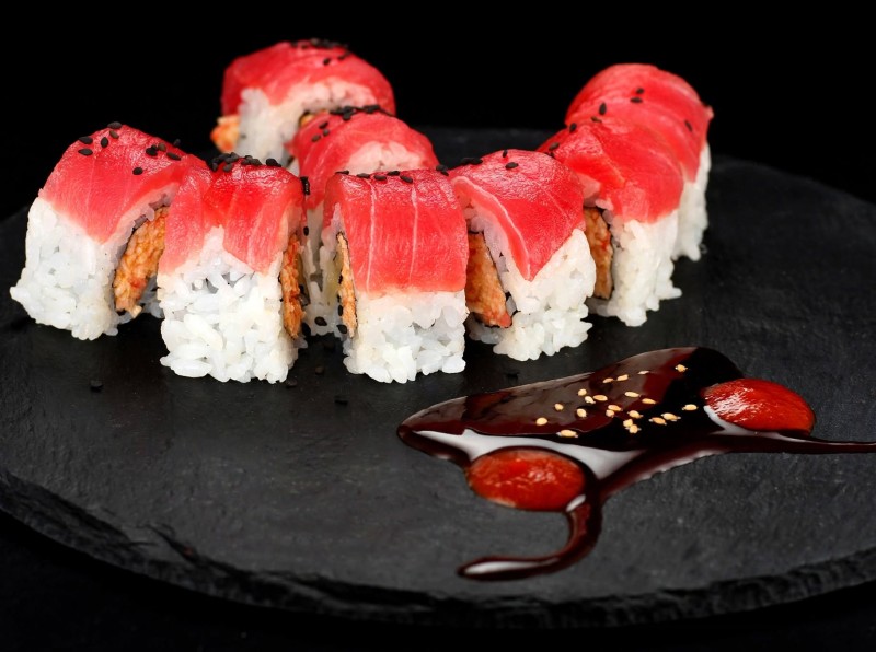 Spicy Crab Mix, Cucumber inside. Tuna on top. Eel Sauce, Spicy Sauce. Lady Bug