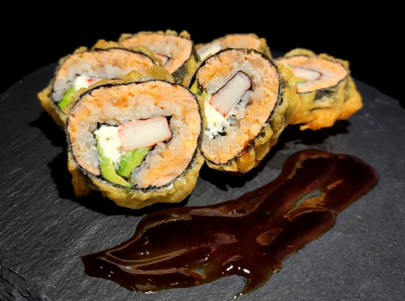 Spicy Salmon, Cream Cheese, Avocado, Crab inside. Deep Fried. Eel Sauce on top. Phoenix Roll
