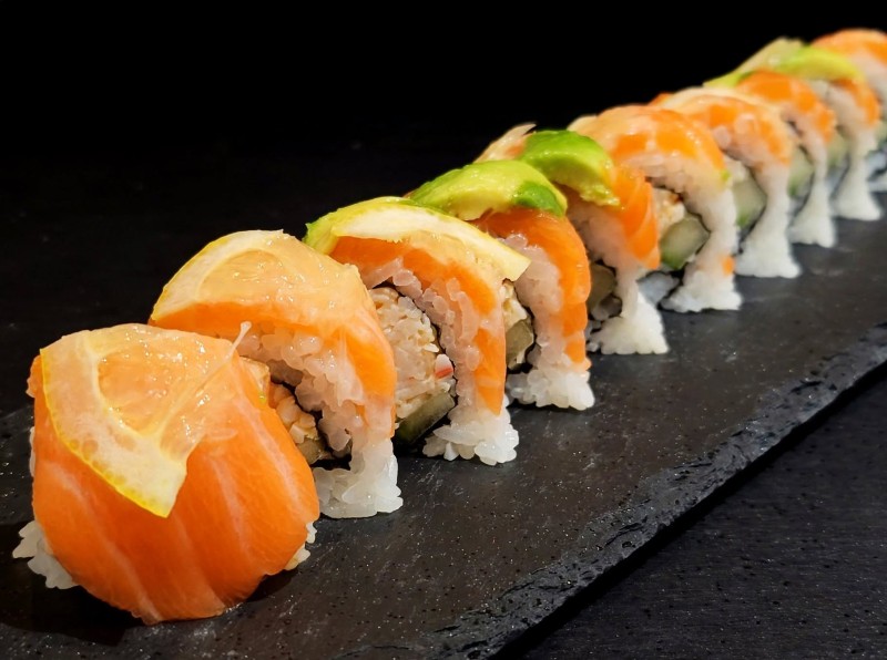 Spicy Crab Mix, Cucumber inside. Salmon, Avocado, Lemon on top Sunrise Roll