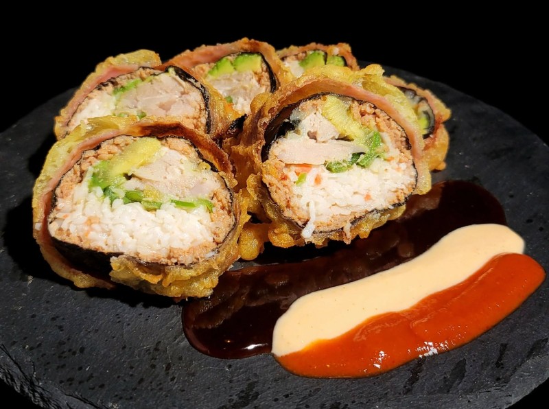 Spicy Tuna, Crab Mix, Albacore, Avocado, Jalapeno inside. Deep Fried. Eel Sauce Spicy Mayo, on top. Tiger Eye Roll